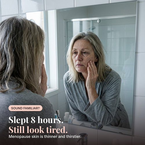 Woman in her 50s looking tired in the bathroom mirror. Menopause skin is thinner and thirstier.